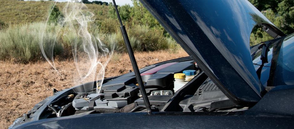 car with hood open showing engine overheating